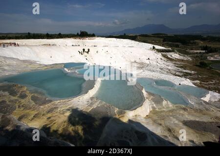 Die Sonne untergeht über den Thermalbecken der Travertinen, auch bekannt als Cotton Castle, in Pamukkale in der Türkei. Stockfoto