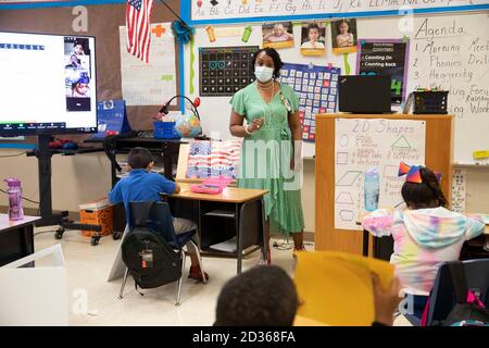 Austin, TX USA 6. Oktober 2020: Unter der aufmerksamen Aufsicht von erfahrener Erstklässellehrerin Nicole Miller und mit viel PPE-Vorbereitung, hebt das persönliche Lernen am zweiten Unterrichtstag im Campbell Elementary in Austin wieder an. Der öffentliche Campus des Austin Independent School District nutzt im Zeitalter des Coronavirus eine Kombination aus fernem und personellem Lernen. Kredit: Bob Daemmrich/Alamy Live Nachrichten Stockfoto