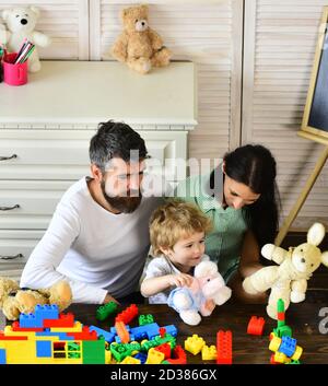 Kid boy, Mutter und Vater spielen Baumeister im Kindergarten zu Hause. Konzept für Familienspiele Stockfoto