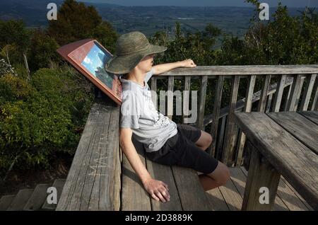 AUCKLAND, NEUSEELAND - 17. März 2019: Auckland / Neuseeland - 17 2019. März: Erschöpfter Tourist auf dem Gipfel des Clevedon Reservewanderwegewegeweg Stockfoto