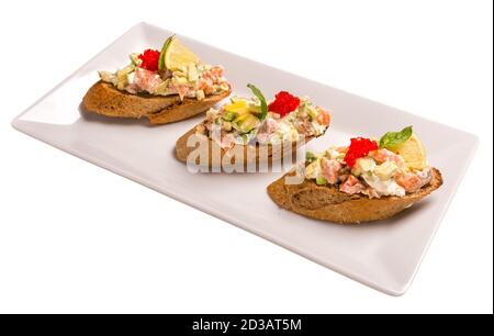 Bruschetta mit Lachs und Avocado. Isoliertes Bild auf weißem Hintergrund. Stockfoto