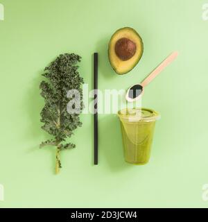 Smoothie-Konzept, frische Kale Gesundheit Lebensmittel in Kunststoff-Glas zum Mitnehmen, gesundes Frühstück, Farbkomposition oben gesehen, Stillleben. Stockfoto