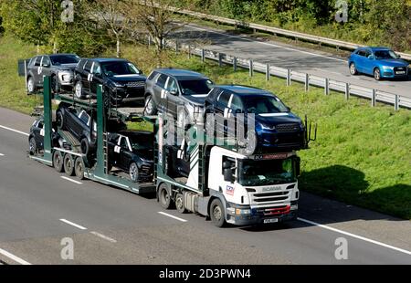 Ein BCA-Autotransporter mit neuen Land Rover Fahrzeugen auf der Autobahn M40, Warwickshire, Großbritannien Stockfoto