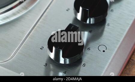 Moderne Gasherd Knöpfe Nahaufnahme, Küchenausstattung Nahaufnahme Hintergrund. Stockfoto