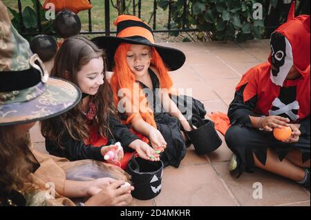 Kinder teilen und vergleichen ihre Süßigkeiten an halloween Stockfoto