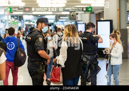 Madrid, Spanien. Januar 2012. Die Polizei überprüft die Reisedokumente am Bahnhof Atocha im Alarmzustand. Die spanische Regierung hat in der Gemeinschaft Madrid wegen der hohen Zahl der Covid-19-Infektionen während der zweiten Pandemiewelle in Spanien 15 Tage lang den Alarmzustand erklärt. Kredit: SOPA Images Limited/Alamy Live Nachrichten Stockfoto