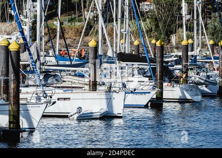 PORTONOVO, SPANIEN - 15. AUGUST 2020: Kleine Segelboote im Yachtclub von Portonovo an einem klaren Sommertag, Pontevedra, Spanien, festgemacht. Stockfoto