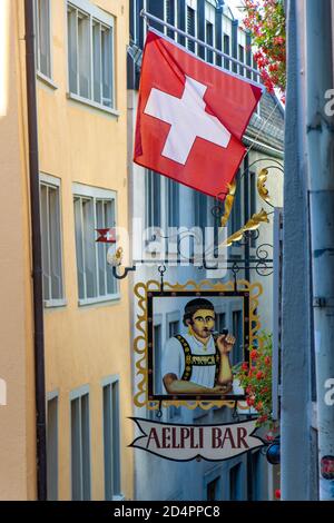 ZÜRICH, SCHWEIZ, 30 2020. JULI, die schweizer Flagge mit hängenden Zeichen der traditionellen Kneipe in der Altstadt, Zürich, Schweiz. Stockfoto
