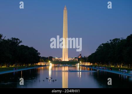 Das Washington Monument spiegelt sich im Lincoln Memorial Reflecting Pool Bei Sonnenuntergang Stockfoto