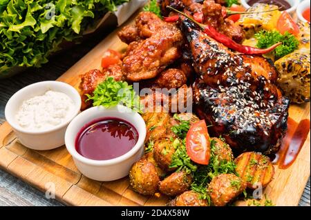 Grillhähnchen mit Gemüse auf Holztisch Stockfoto