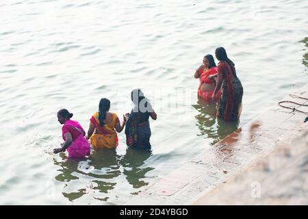 Dezember 17 2019 Varanasi, Indien. Eine Gruppe indischer Frauen führt im Ganges eine heilige Waschung durch. Draufsicht von hinten. Stockfoto