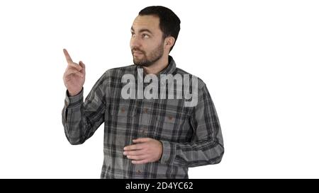 Schöner junger Mann zu Fuß und Blick auf die Kamera und pointin Stockfoto