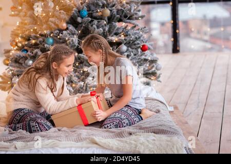 Happy Kids Spaß und Eröffnung präsentiert in der Nähe der Weihnachtsbaum. Stockfoto