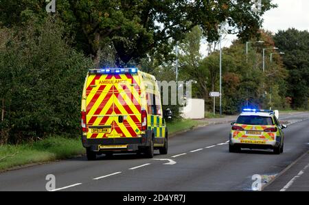 Ein Krankenwagen und Polizeiwagen mit blauen Blinklichtern, Warwick, Großbritannien Stockfoto