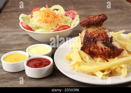 Peruanisches Essen namens Pollo a la Brasa mit Salat und pommes frites Stockfoto