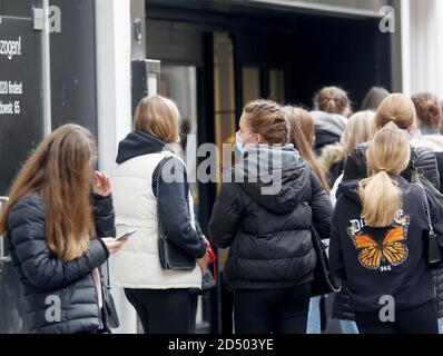 Düsseldorf, Deutschland. Oktober 2020. Passanten mit und ohne Mund-Nase-Schutz gehen durch eine Einkaufsstraße. In vielen Großstädten in Nordrhein-Westfalen ist die Zahl der neuen Coronainfektionen pro 100,000 Einwohner innerhalb einer Woche über die entscheidende Schwelle von 50 gestiegen. Quelle: Roland Weihrauch/dpa/Alamy Live News Stockfoto