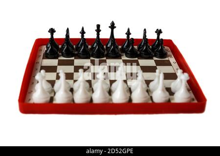 Schachbrett aus Kunststoff isoliert auf weißem Hintergrund. Reisen Sie Schach. Selektiver Fokus. Konzentrieren Sie sich auf schwarze Stücke. Stockfoto