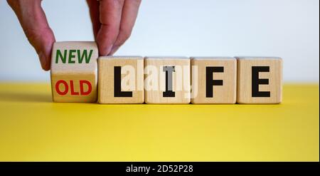 Neues Lebenskonzept für den Neuanfang, neue Jahr Auflösung, Diät und gesunde Lebensweise. Hand dreht einen Würfel und ändert die Worte "altes Leben" zu "neu Stockfoto