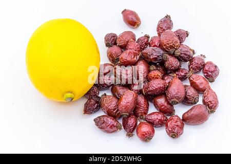 Getrocknete Hagebutte und Zitrone, Vitamin C in Zitrone und Hagebutte, gelbe Zitrone und Hagebutte Stockfoto