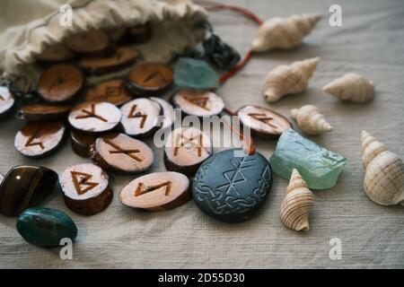 Hölzerne Runen in einem Leinwandbeutel mit einem steinernen Runescript Stockfoto