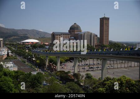 Aparecida, Brasilien. Oktober 2020. Die Basilika von Nossa Senhora Aparecida kann von der Fußgängerbrücke Passarela da Fe gesehen werden, am Tag von Nossa Senhora Aparecida, der schutzpatronin von Brasilien. Zum ersten Mal in der Geschichte der Basilika mussten wegen der Corona-Pandemie die Messen hinter verschlossenen Türen oder in Anwesenheit einer kleinen Anzahl von Menschen gefeiert werden. Quelle: Fernando Souza/dpa/Alamy Live News Stockfoto