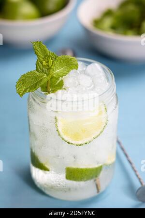 Mojito Cocktail auf blauem Tisch. Einige Zutaten und Werkzeuge als Hintergrund Stockfoto