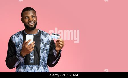 Happy Black guy online einkaufen, mit Handy Stockfoto