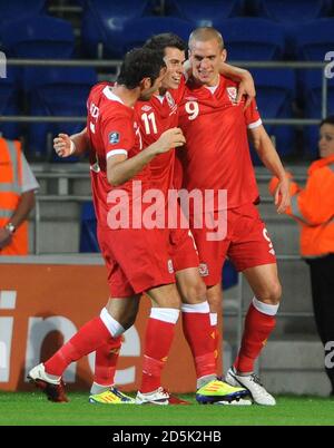 Steve Morison aus Wales (rechts) feiert mit Joe Ledley (links) und Gareth Bale (Mitte) sein Tor gegen Montenegro. Stockfoto