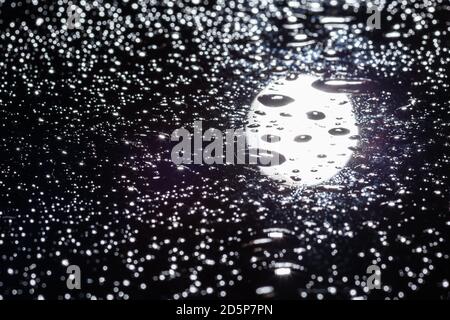 Wassertropfen auf schwarzem Glas Stockfoto