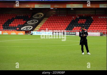 Billy Clifford von Crawley Town liest vor dem zweiten Spiel der Sky Bet League zwischen Crewe Alexandra und Crawley Town ein Spieltagsprogramm auf dem Spielfeld. Stockfoto