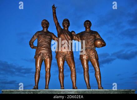 Ein Blick auf die Statue der 'Holy Trinity' von Manchester United von Sir Bobby Charlton, George Best und Denis Law vor dem Stadion Stockfoto