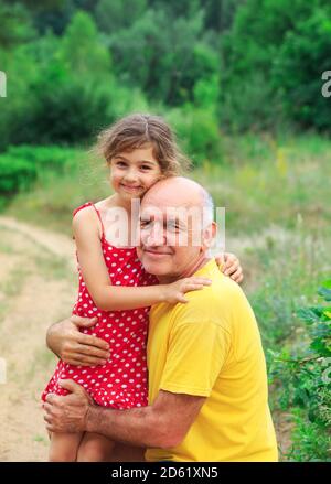 Portrait von glücklicher Großvater und Enkelin, die im Park spielen Stockfoto