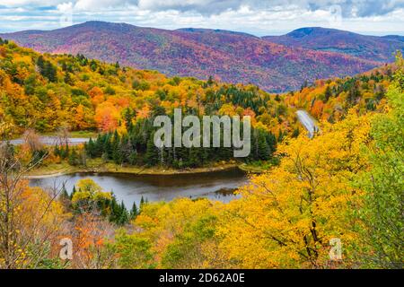 Die Straße schlängelt sich durch die Appalachian Gap, einen Bergpass in den Green Mountains von Vermont, in hellem Herbstlaub Stockfoto