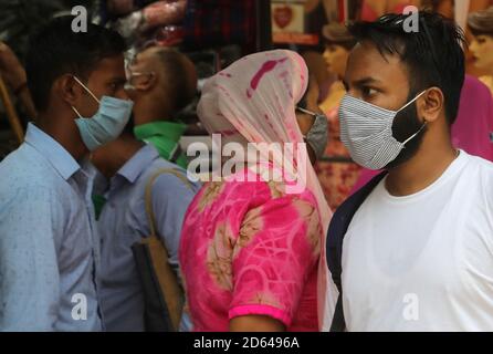 Neu Delhi, Indien. Oktober 2020. Menschen mit Gesichtsmasken gehen an einem Modehaus vorbei.in Indien wurden an einem einzigen Tag mehr als 63,509 Fälle von Coronavirus gemeldet, und 7,239,389 bestätigte Fälle von Covid-19 mit 110, 586 Todesfällen. Kredit: Naveen Sharma/SOPA Images/ZUMA Wire/Alamy Live Nachrichten Stockfoto