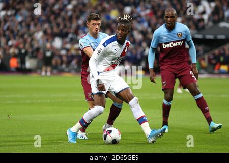 West Ham United kämpfen Aaron Cresswell (links) und Wilfried Zaha (Mitte) von Crystal Palace um den Ball Stockfoto