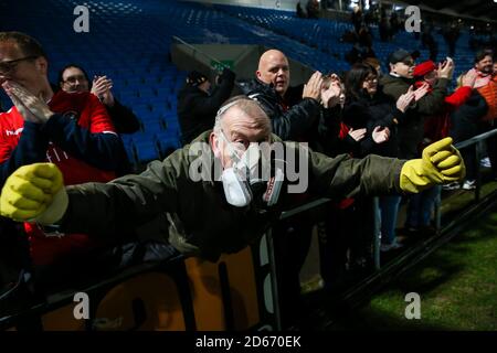 Ein Ebbsfleet Fan, der eine Schutzmaske trägt, feiert den Sieg gegen den FC Halifax Town während des Premier-League-Spiels der Vanarama Conference im Shay Stockfoto