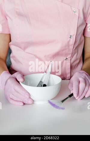 Kosmetikerin hält kosmetische Produkte. Stockfoto