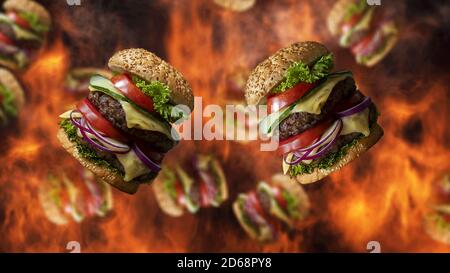 Hamburger fallen mit Rauch und brennendem Feuer im Hintergrund. Sonderangebot für Fast Food-Menüs Stockfoto