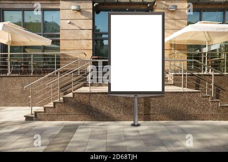 Vor dem Eingang einer Boutique oder eines Cafés ist ein leerer Plakatstand zu sehen. Stockfoto