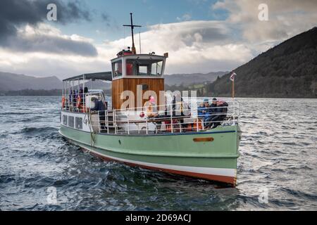 Der Ullswater-Dampfer die Western Belle nähert sich an einem feuchten und launischen Wintertag kurz vor Weihnachten an der Spitze von Ullswater im Seengebiet mit Passagieren, die sich gegen die Kälte auf ihrem Deck einwickeln und die Crew sich zum Andocken bereit machen. 23 Dezember 2019. Foto: Neil Turner Stockfoto