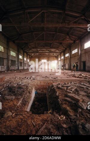 Verlassene Ruine Hangar mit hohem Dach am Tag. Im Inneren des verlassenen Gebäudes Stockfoto