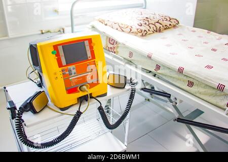 Hintergrund des neuen gelben Defibrillators im Krankenhaus für die medizinische Versorgung. Stockfoto