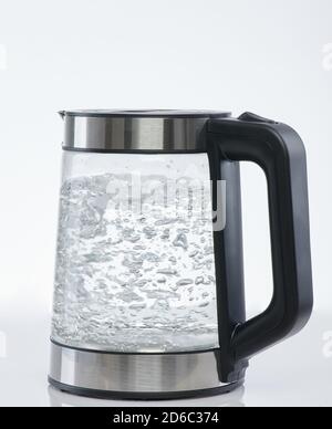 Kochendes Wasser im Kessel isoliert auf weißem Studiohintergrund Stockfoto