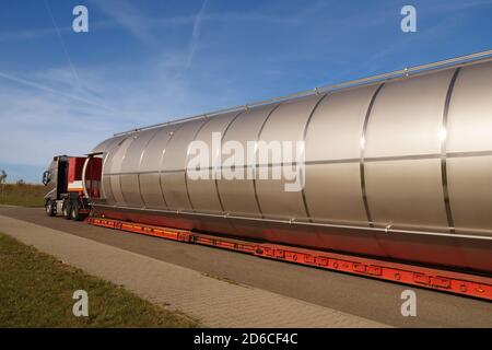 Straßenverkehr. Langes Fahrzeug. Ein LKW mit einer ungewöhnlichen, ungewöhnlich langen Last auf dem Anhänger. Stockfoto