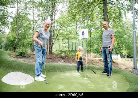 Familie spielt Minigolf Stockfoto