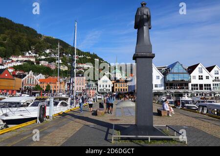 BERGEN, NORWEGEN - 23. JULI 2020: Besucher besuchen den Stadtteil Bryggen in Bergen, Norwegen. Es ist ein UNESCO-Weltkulturerbe. Stockfoto