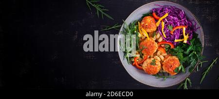 Italienische Pasta. Cavatappi mit Fleischbällchen und Salat auf dunklem Hintergrund. Abendessen. Draufsicht, Banner. Slow Food Konzept Stockfoto