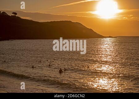 Langland Bay, Swansea, Großbritannien. Oktober 2020. Die Sonne geht heute Morgen in der Langland Bay nahe Swansea auf, während Schwimmer das Herbstwetter während des Lockdown optimal nutzen. Quelle: Phil Rees/Alamy Live News Stockfoto