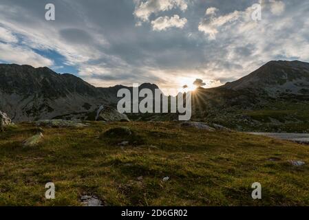 Erstaunlicher Sonnenuntergang mit Gipfeln und blauem Himmel mit Wolken darüber Bucura See in Retezat Berge in Rumänien Stockfoto