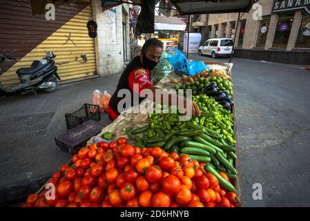 Gaza, Palästina. Oktober 2020. Ein palästinensischer Gemüseverkäufer mit Gesichtsmaske in Khan Yunis im südlichen Gaza-Streifen. Kredit: Yousef Masoud/SOPA Images/ZUMA Wire/Alamy Live Nachrichten Stockfoto